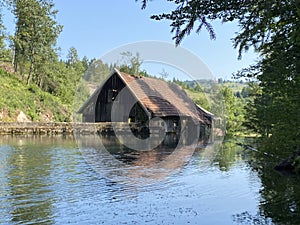 Remains of an old sawmill on the small dam of ÃÅogrljevo Lake in the mountain hamlet of TiÃâ¡i - Gorski kotar, Croatia photo